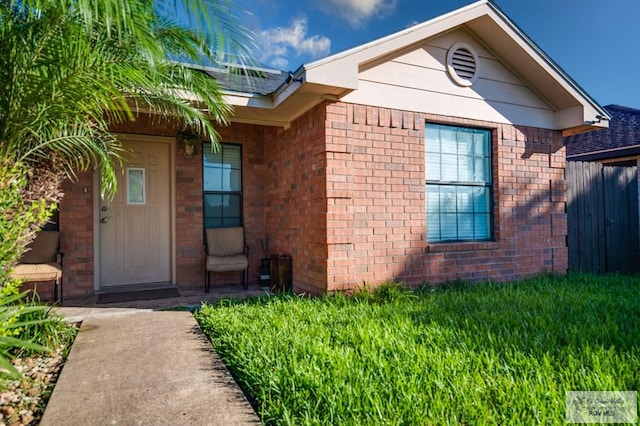 entrance to property featuring a yard