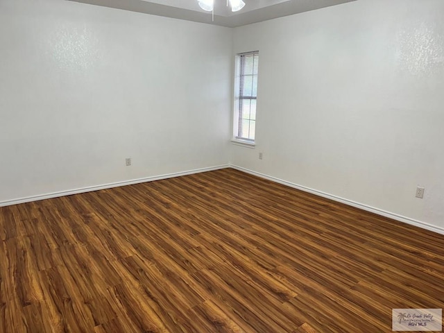 empty room featuring ceiling fan and dark wood-type flooring