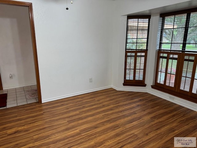 unfurnished room featuring hardwood / wood-style flooring