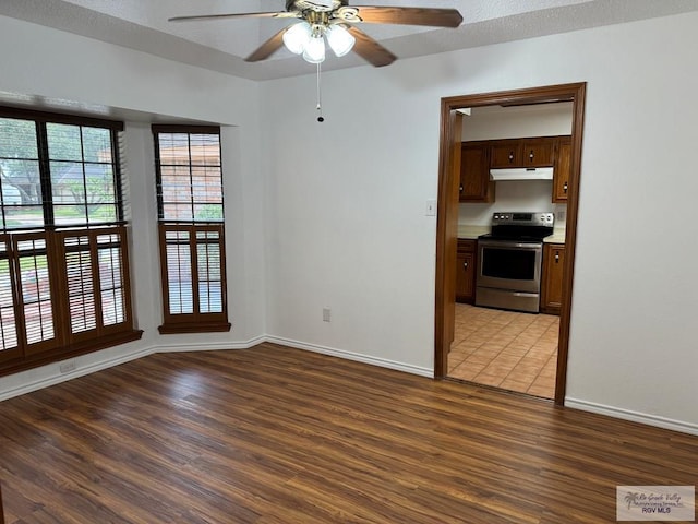 spare room featuring a textured ceiling, hardwood / wood-style flooring, and ceiling fan