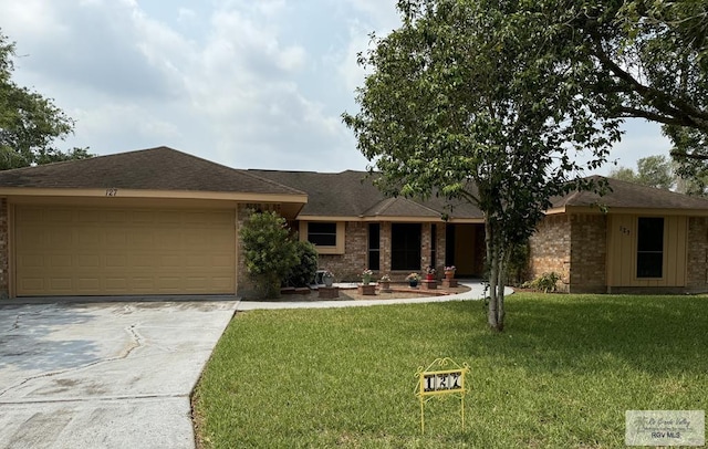 single story home with a front lawn and a garage