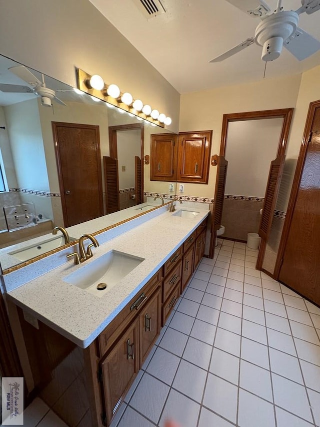 bathroom with tile patterned floors, vanity, ceiling fan, and toilet