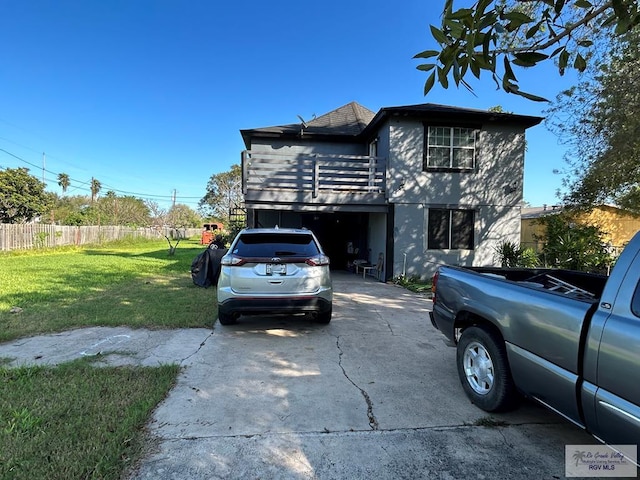 view of front of house featuring a deck and a front lawn