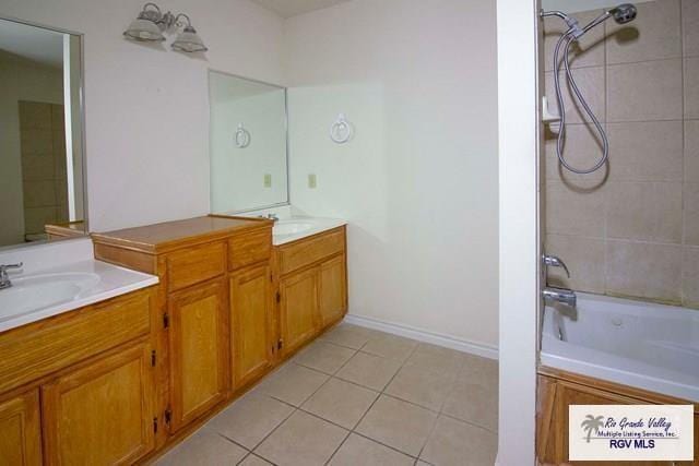 bathroom with vanity, tile patterned floors, and tiled shower / bath