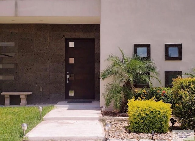 doorway to property with stucco siding