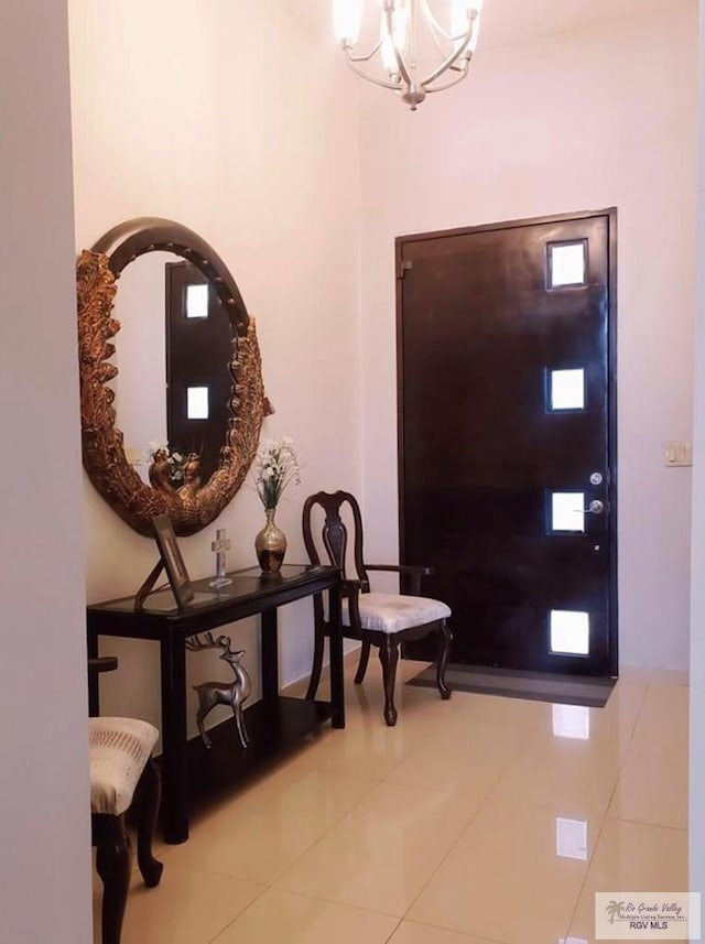 tiled entryway featuring a chandelier