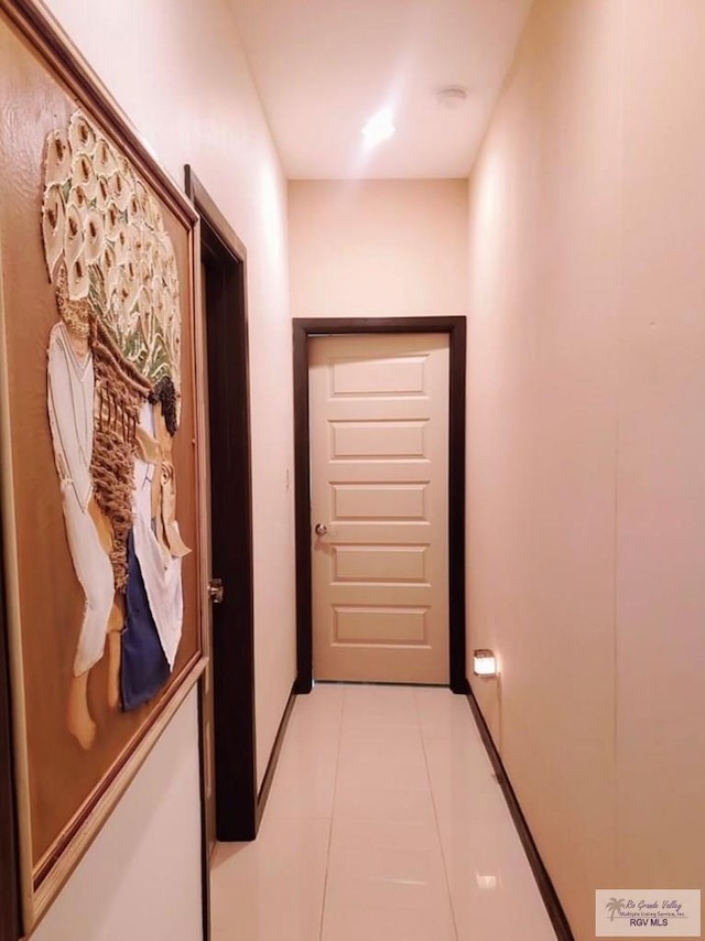 corridor with light tile patterned floors