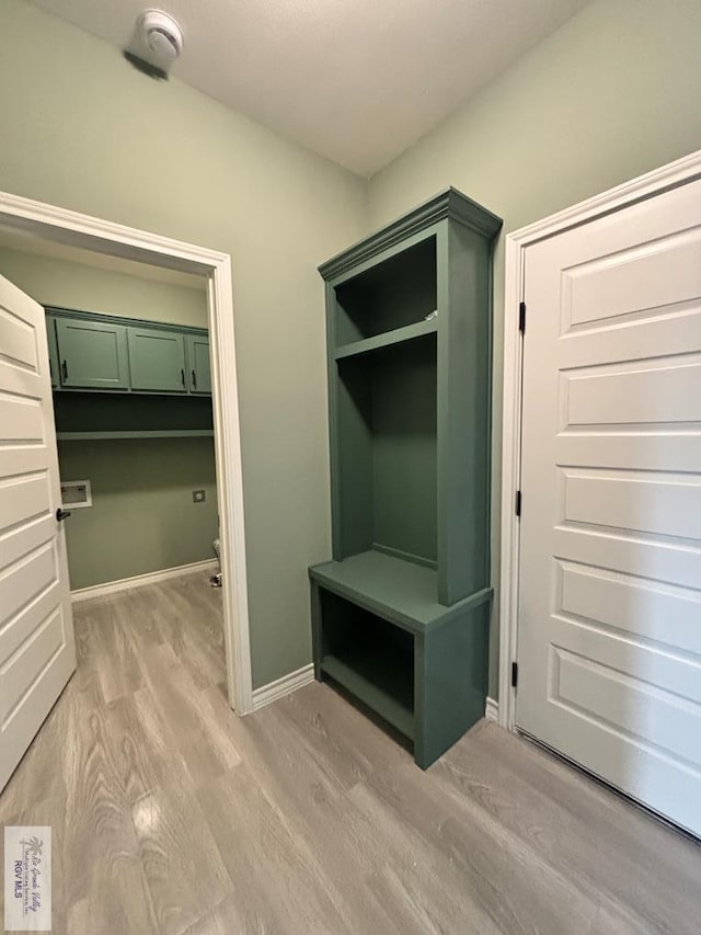 mudroom with light hardwood / wood-style floors