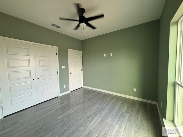 unfurnished bedroom featuring wood-type flooring, a closet, and ceiling fan