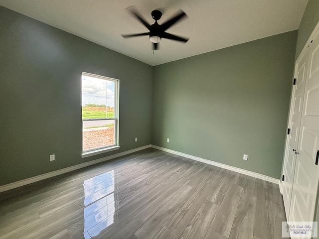 empty room featuring ceiling fan and light hardwood / wood-style flooring