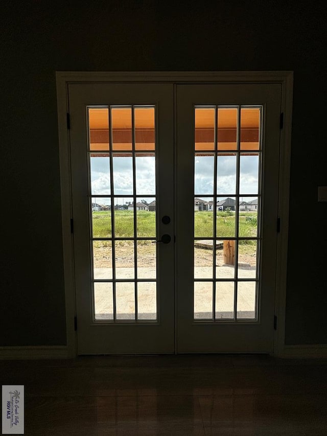 entryway with french doors and tile patterned flooring