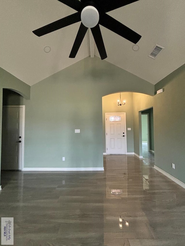 foyer entrance with ceiling fan with notable chandelier and vaulted ceiling