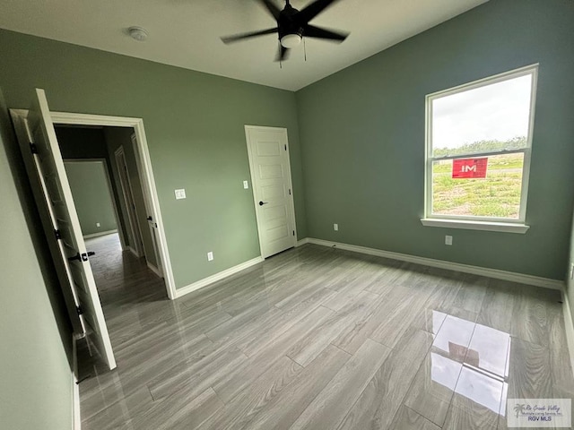 unfurnished bedroom featuring ceiling fan and light hardwood / wood-style flooring