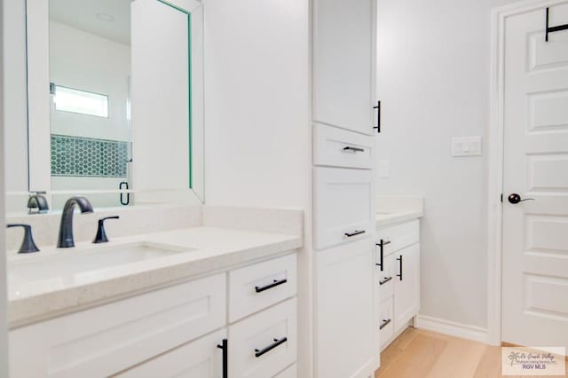 bathroom with hardwood / wood-style floors and vanity