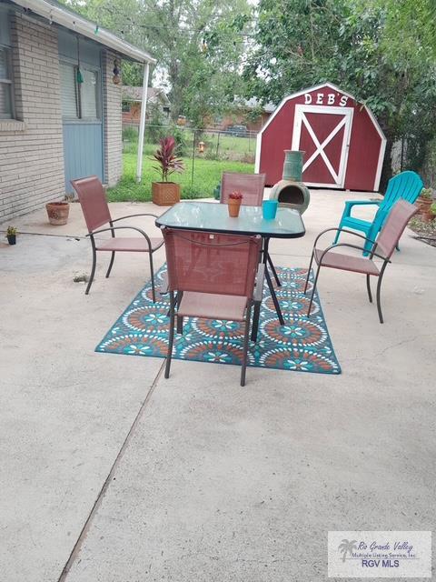 2226 E Austin Ave, Harlingen, TX 78550 - view of patio with a storage unit and outdoor dining area