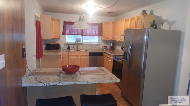 2226 E Austin Ave, Harlingen, TX 78550 - kitchen with appliances with stainless steel finishes, light brown cabinetry, tile patterned floors, and a peninsula