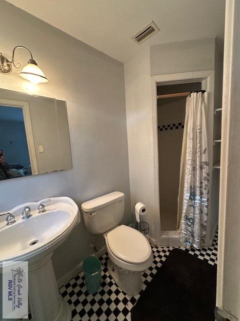 2226 E Austin Ave, Harlingen, TX 78550 - bathroom featuring a shower stall and toilet