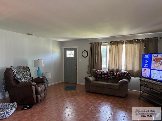 2226 E Austin Ave, Harlingen, TX 78550 - living area featuring tile patterned floors and baseboards