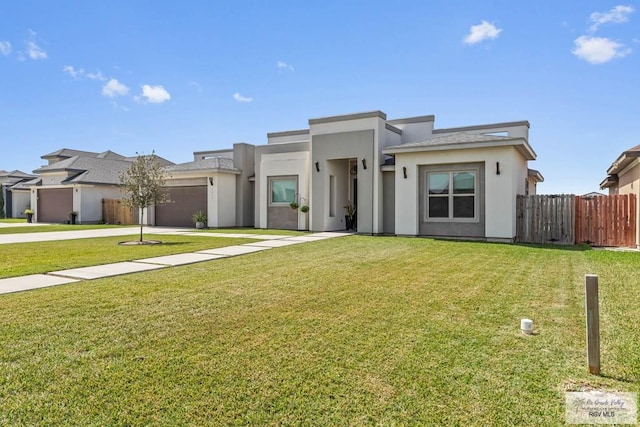 view of front of home with a front yard, fence, stucco siding, concrete driveway, and a garage