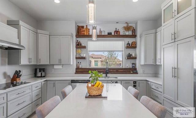 kitchen with open shelves, a sink, wall chimney range hood, black electric stovetop, and light countertops