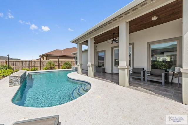 view of swimming pool with a patio area, a fenced in pool, a ceiling fan, and fence