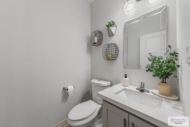 bathroom featuring toilet and vanity