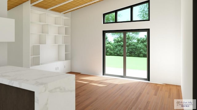 doorway with wood ceiling, vaulted ceiling, and light wood-type flooring