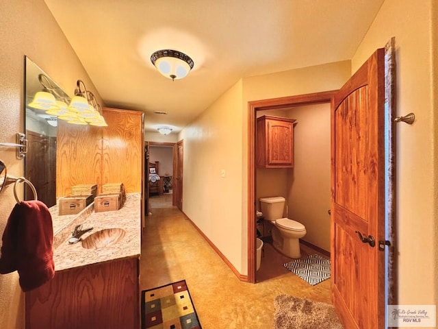 bathroom featuring vanity and toilet
