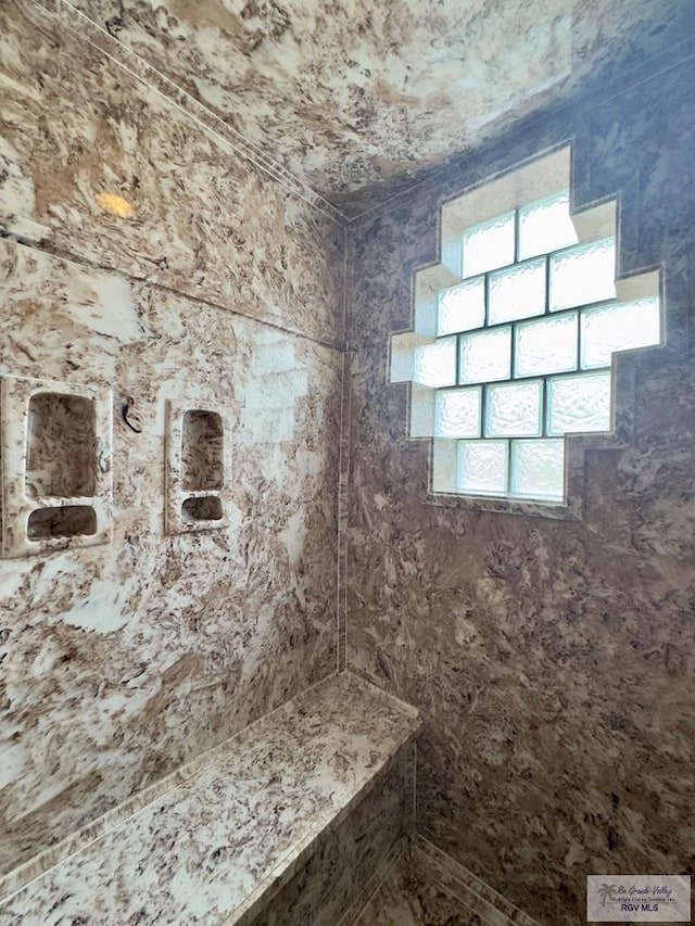 bathroom featuring tiled shower