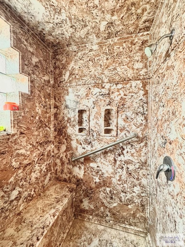 bathroom with tiled shower