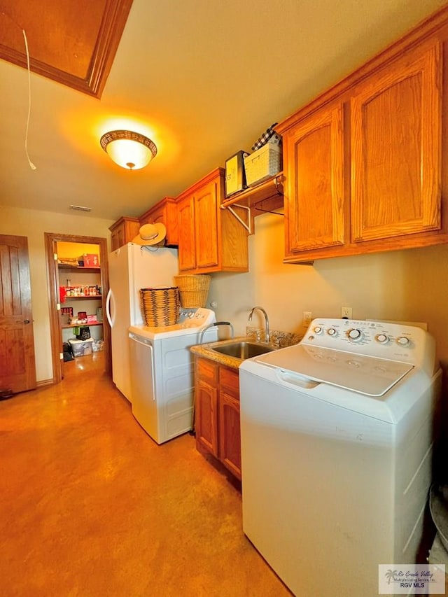 washroom featuring cabinets, independent washer and dryer, and sink