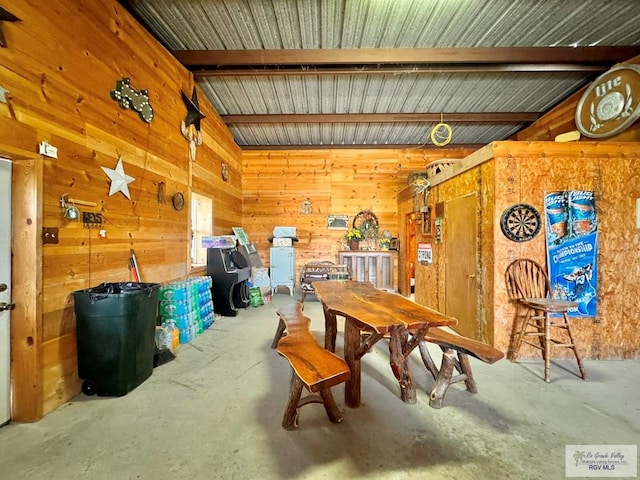 interior space featuring wood walls and concrete flooring