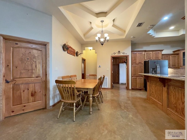 dining area with a raised ceiling and an inviting chandelier