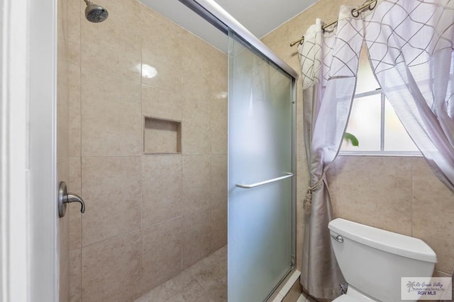 bathroom featuring toilet and walk in shower