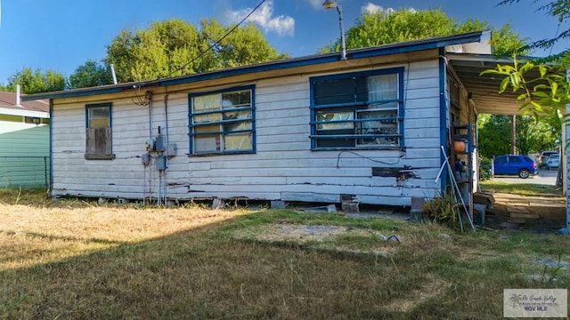 view of side of home featuring a lawn