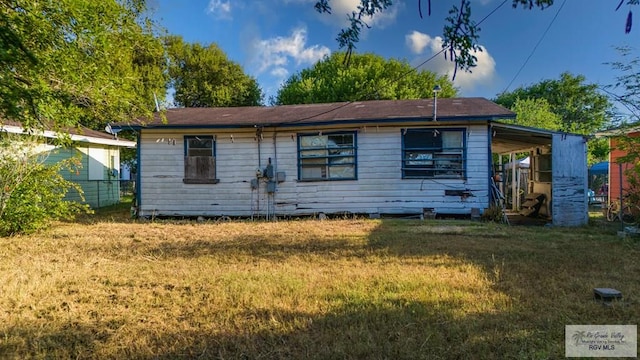 back of property featuring a lawn