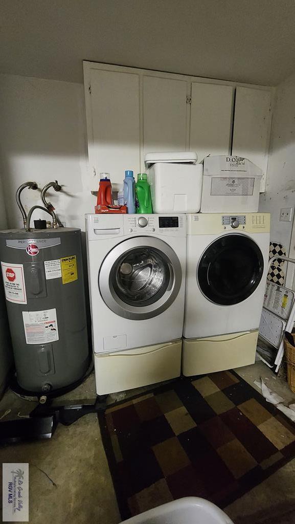 washroom featuring washing machine and dryer and water heater