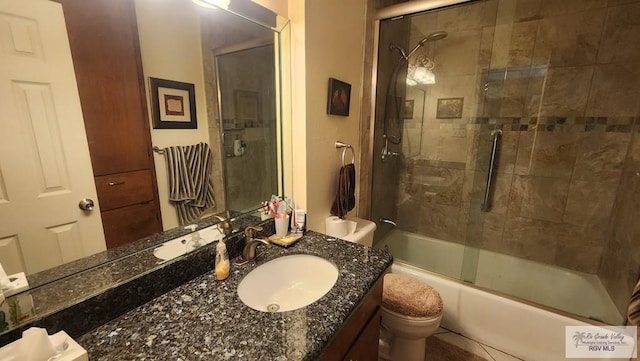 full bathroom with combined bath / shower with glass door, vanity, tile patterned floors, and toilet