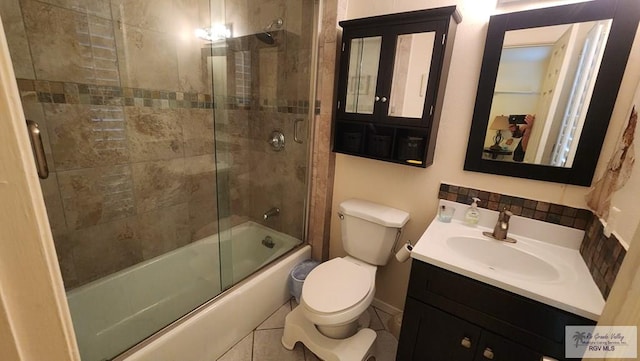 full bathroom with toilet, vanity, and combined bath / shower with glass door