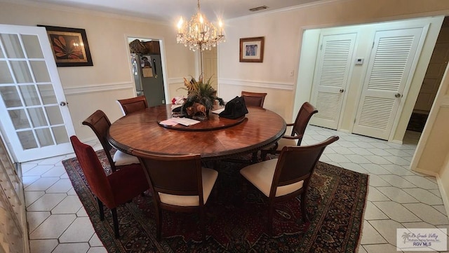 dining area featuring ornamental molding and an inviting chandelier