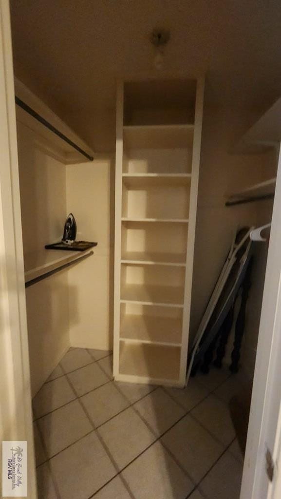 spacious closet featuring tile patterned flooring