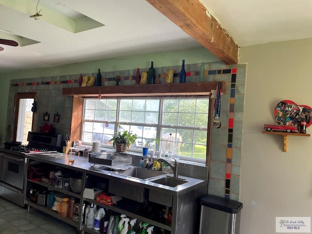 125 W Resaca Rd, Bayview, TX 78566 - kitchen featuring gas stove, tile patterned flooring, ceiling fan, and beam ceiling