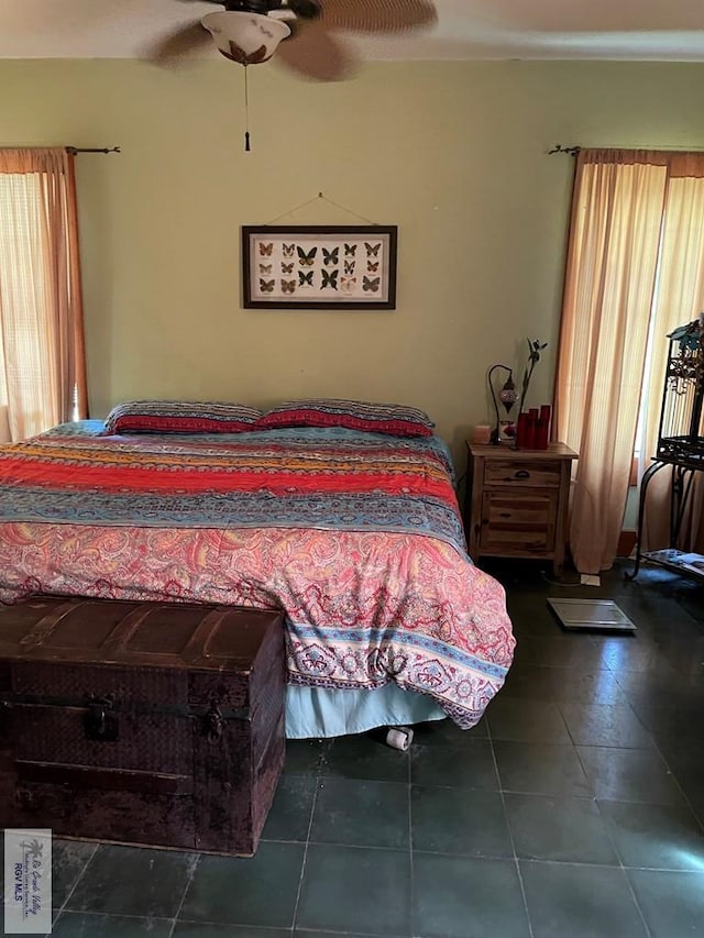 125 W Resaca Rd, Bayview, TX 78566 - bedroom featuring multiple windows, dark tile patterned floors, and ceiling fan
