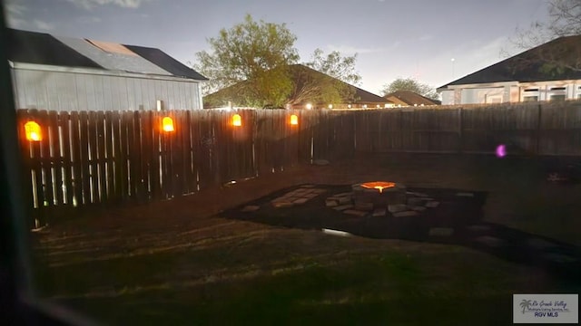 view of patio featuring a fenced backyard and an outdoor fire pit