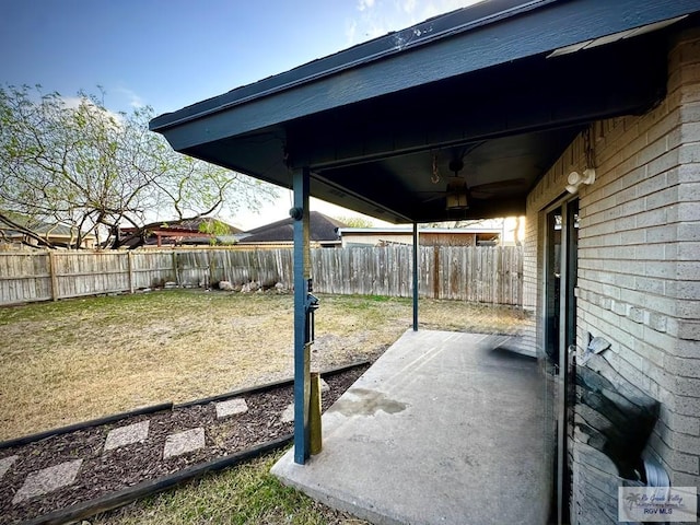 view of patio featuring fence and ceiling fan