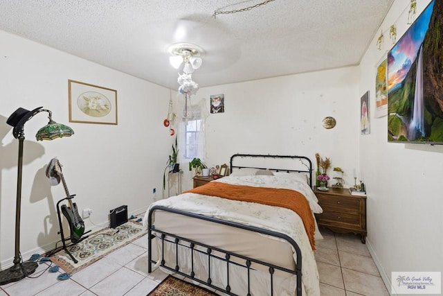 tiled bedroom featuring a textured ceiling