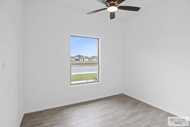 unfurnished room featuring ceiling fan, baseboards, and wood finished floors