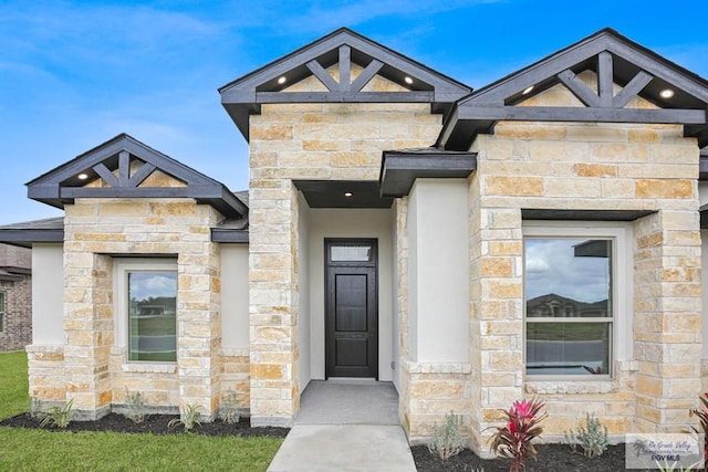 view of exterior entry featuring stone siding