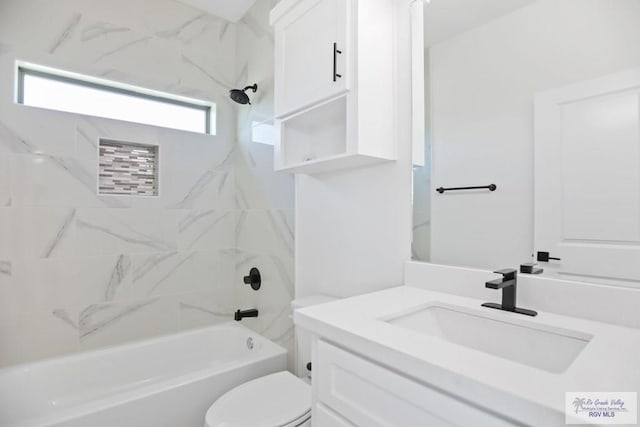 bathroom featuring toilet, vanity, and shower / bathtub combination