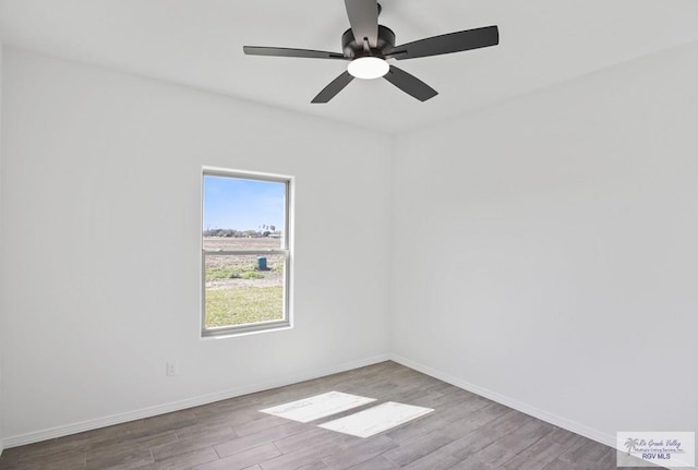 unfurnished room featuring ceiling fan, baseboards, and wood finished floors